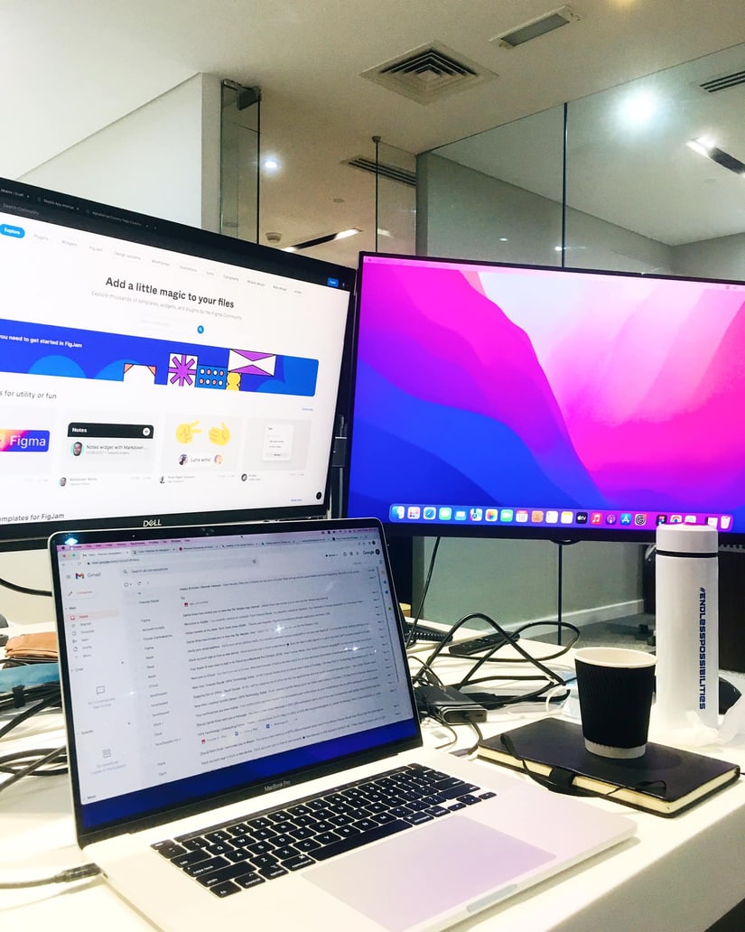 Two extra monitors and a coffee gone cold